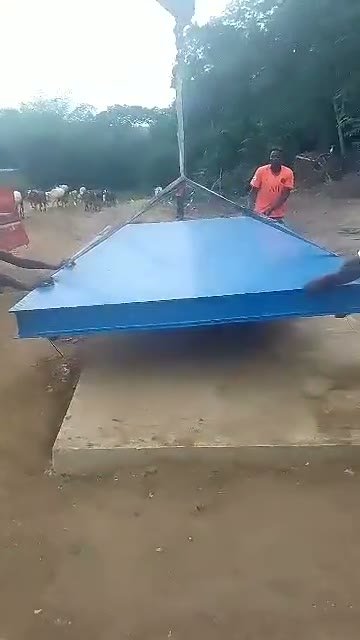 Weighbridge deck being lifted into place by crane